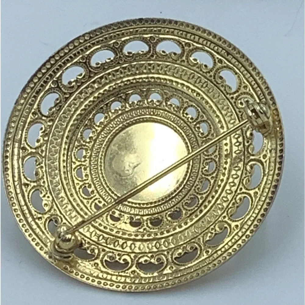 Gold Tone Round Filigree Brooch with Red/Purple Stone